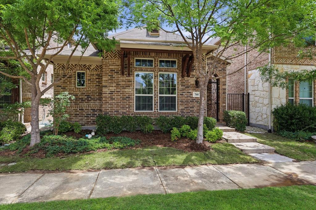 768 Huntingdon Street Coppell, TX 75019 - Photo 31 of 37 Timeless brick architecture, decorative masonry, and warm wood accents create a standout first impression in this picture-perfect Coppell home.