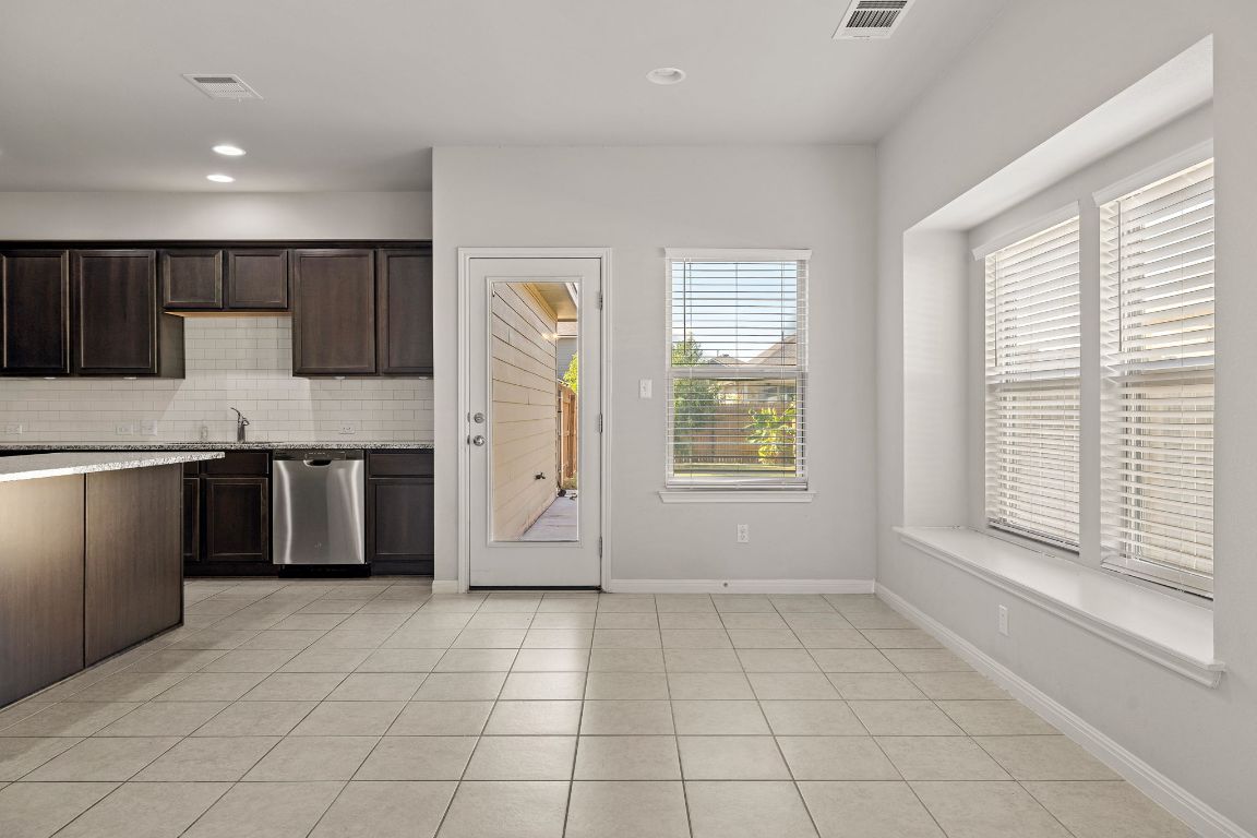 321 Arabian Colt Drive Georgetown, TX 78626 - Photo 12 of 24 a kitchen with a stove a sink and a refrigerator