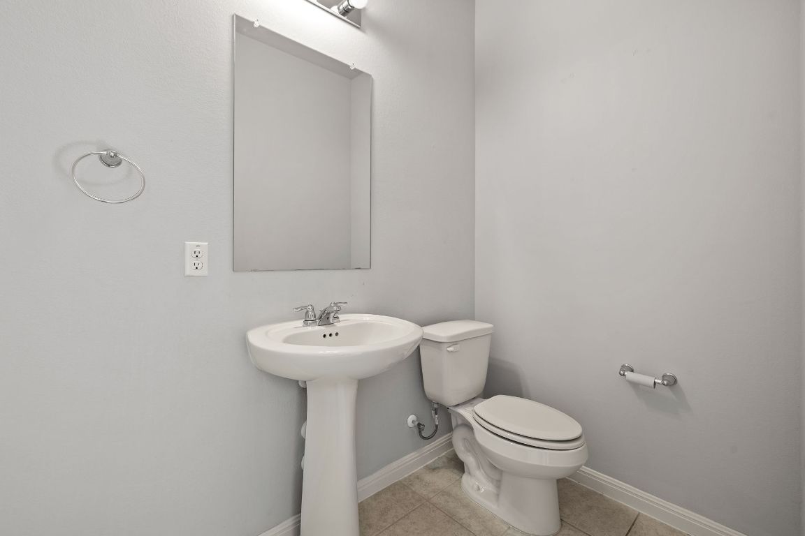 321 Arabian Colt Drive Georgetown, TX 78626 - Photo 13 of 24 a bathroom with a sink a toilet and mirror