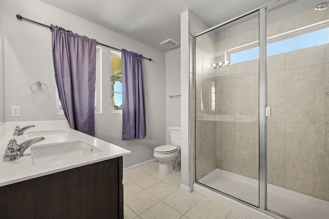 321 Arabian Colt Drive Georgetown, TX 78626 - Photo 15 of 24 a bathroom with a sink a toilet and shower