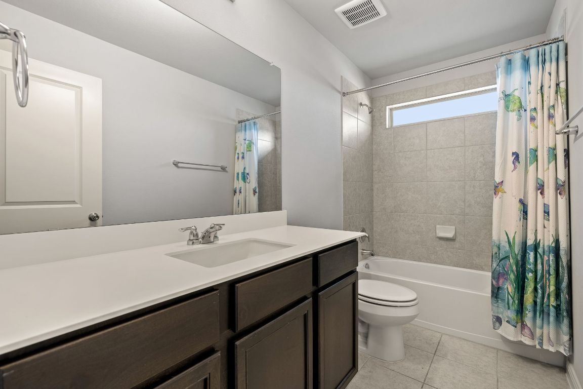 321 Arabian Colt Drive Georgetown, TX 78626 - Photo 18 of 24 a bathroom with a sink a toilet a tub and shower