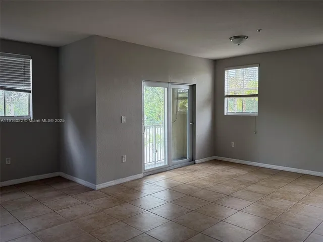 an empty room that has a window in it