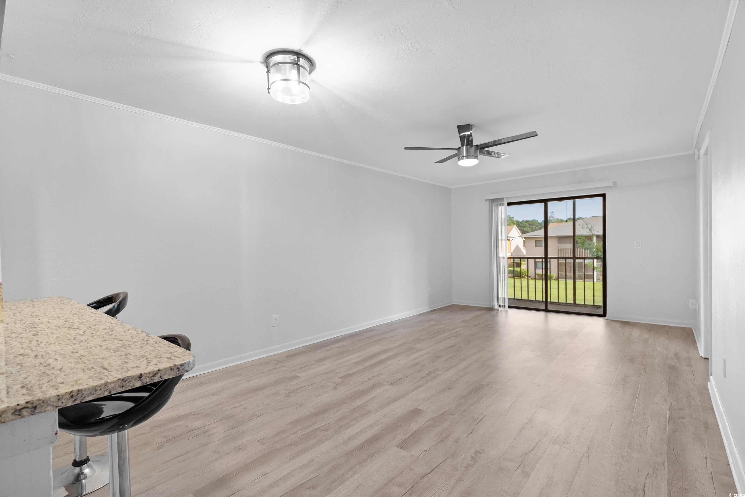 1301 Pridgen Road, Unit 1008 Myrtle Beach, SC 29577 - Photo 6 of 23 Unfurnished living room with ceiling fan, crown mo