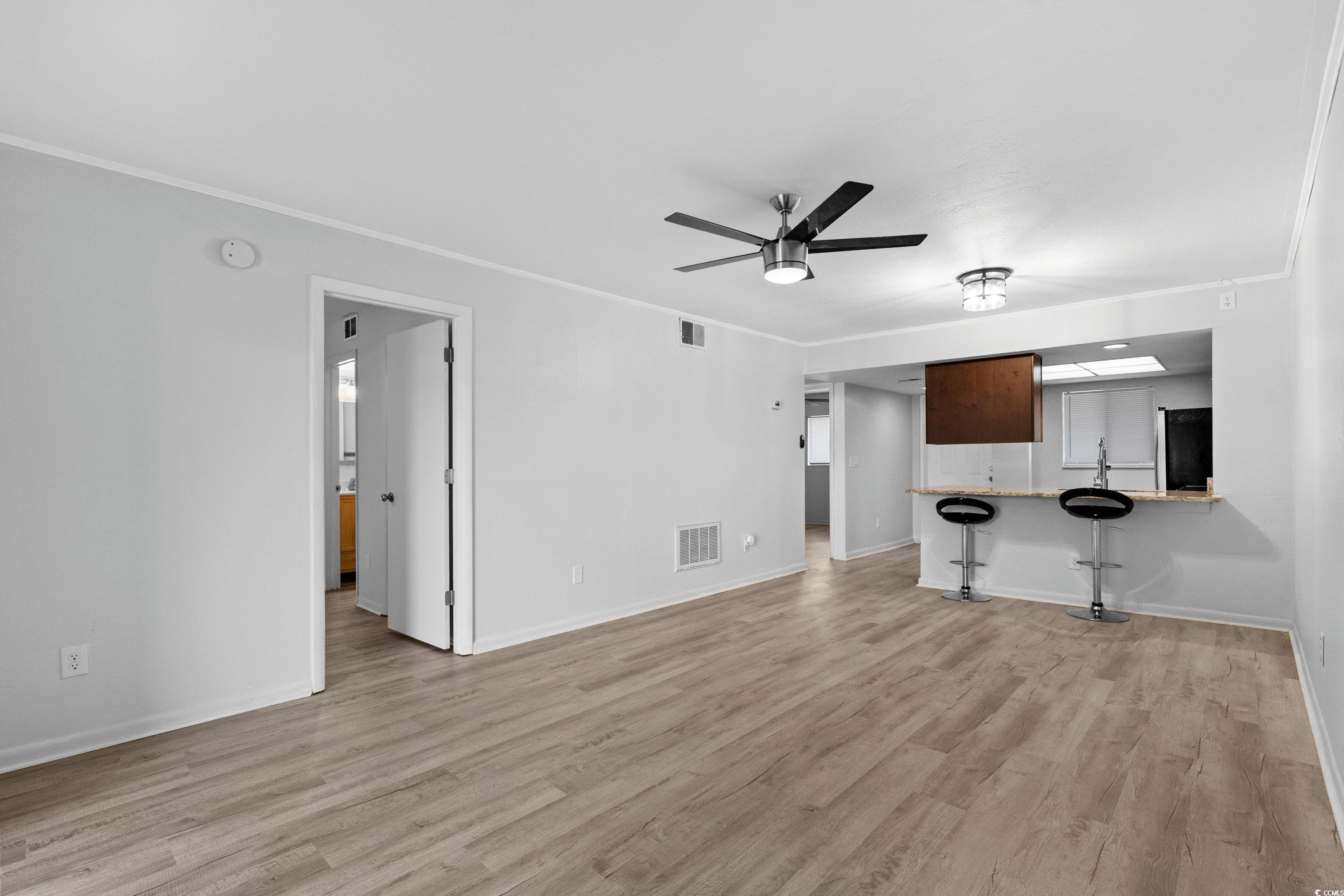 1301 Pridgen Road, Unit 1008 Myrtle Beach, SC 29577 - Photo 8 of 23 Unfurnished living room with crown molding, ceilin