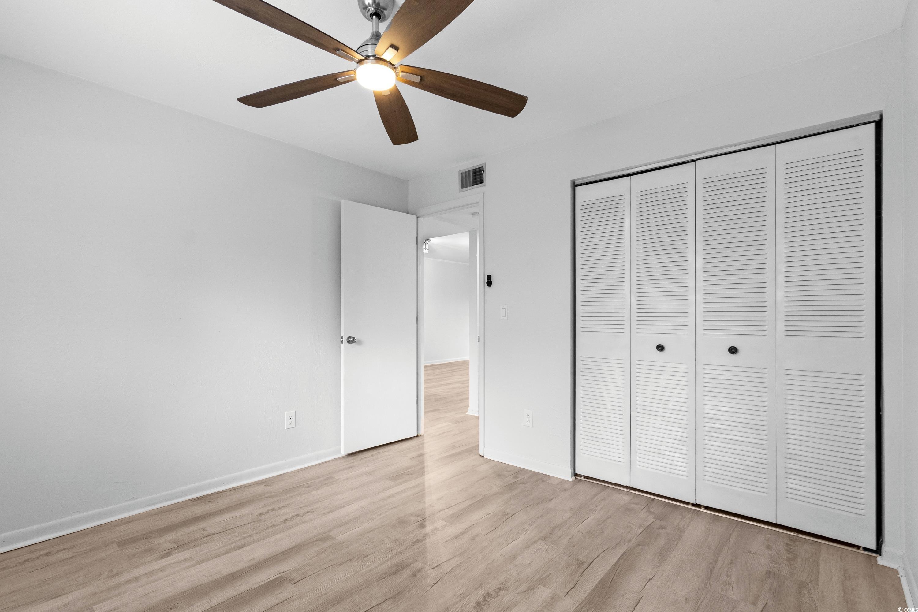 1301 Pridgen Road, Unit 1008 Myrtle Beach, SC 29577 - Photo 10 of 23 Unfurnished bedroom featuring ceiling fan, light h