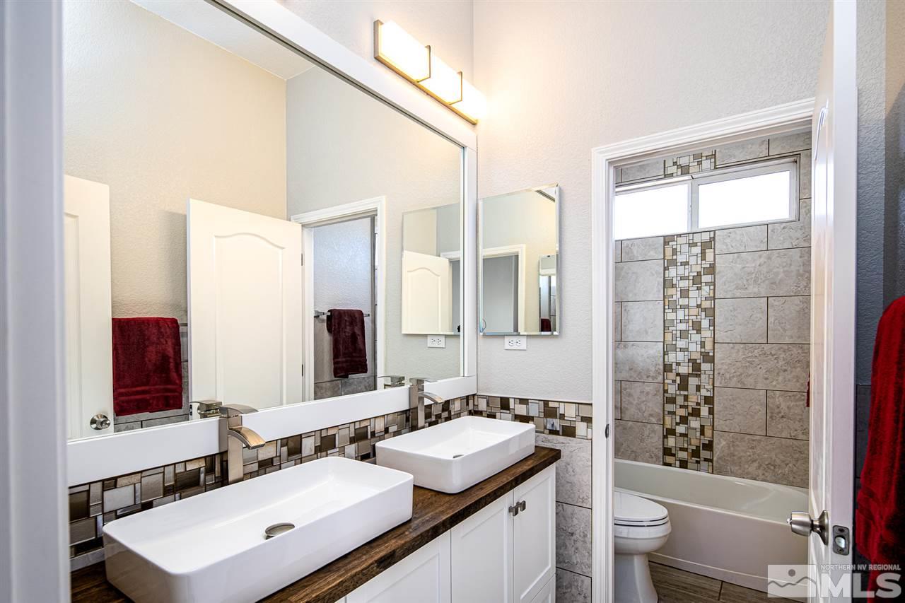 10535 Autumn Walk Court Reno, NV 89521 - Photo 17 of 25 a bathroom with a sink a toilet a mirror and shower
