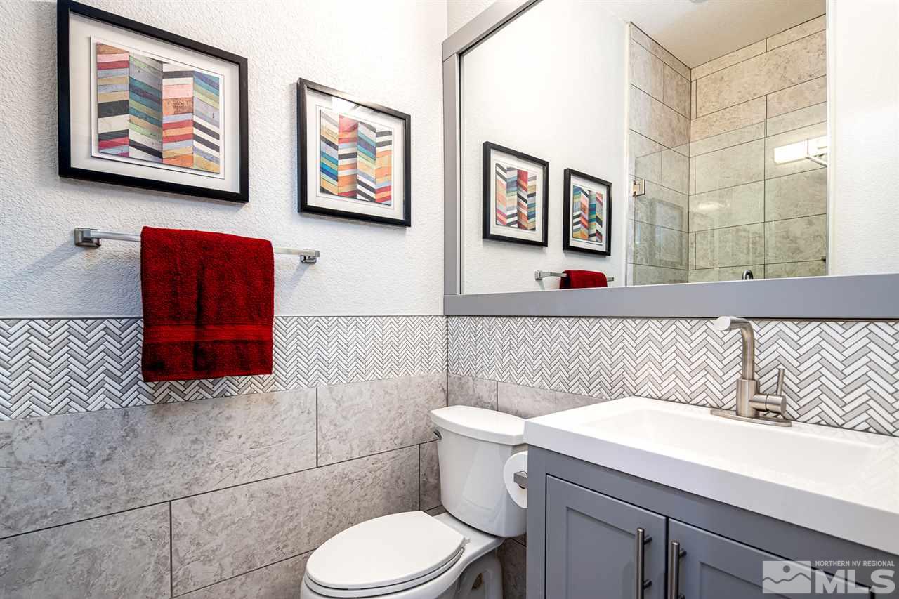 10535 Autumn Walk Court Reno, NV 89521 - Photo 18 of 25 a bathroom with a toilet a sink and a shower curtain