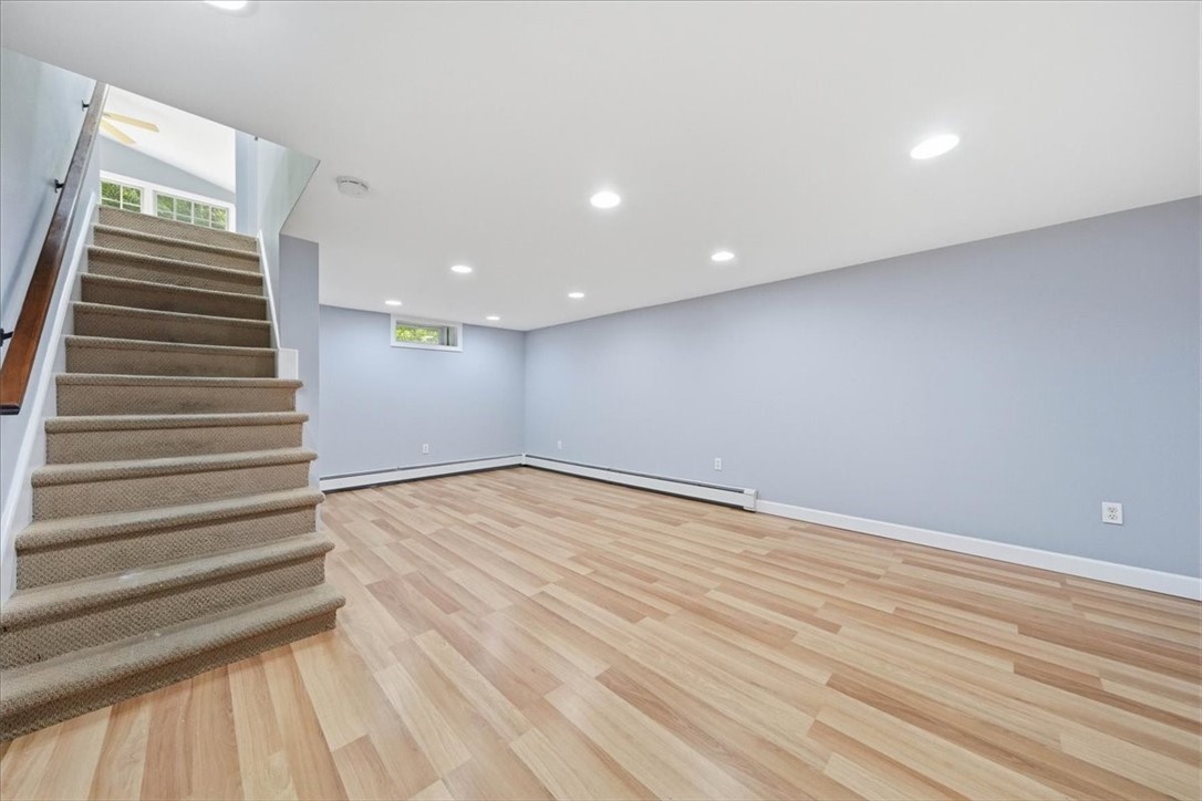 214 Anan Wade Road Glocester, RI 02857 - Photo 25 of 50 The finished walk-out lower level begins with a spacious family room offering plenty of flexibility for everyday living, entertaining, gaming, movie nights, a home gym, or additional work-from-home space.