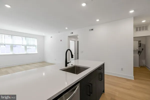 a kitchen with a sink and a refrigerator