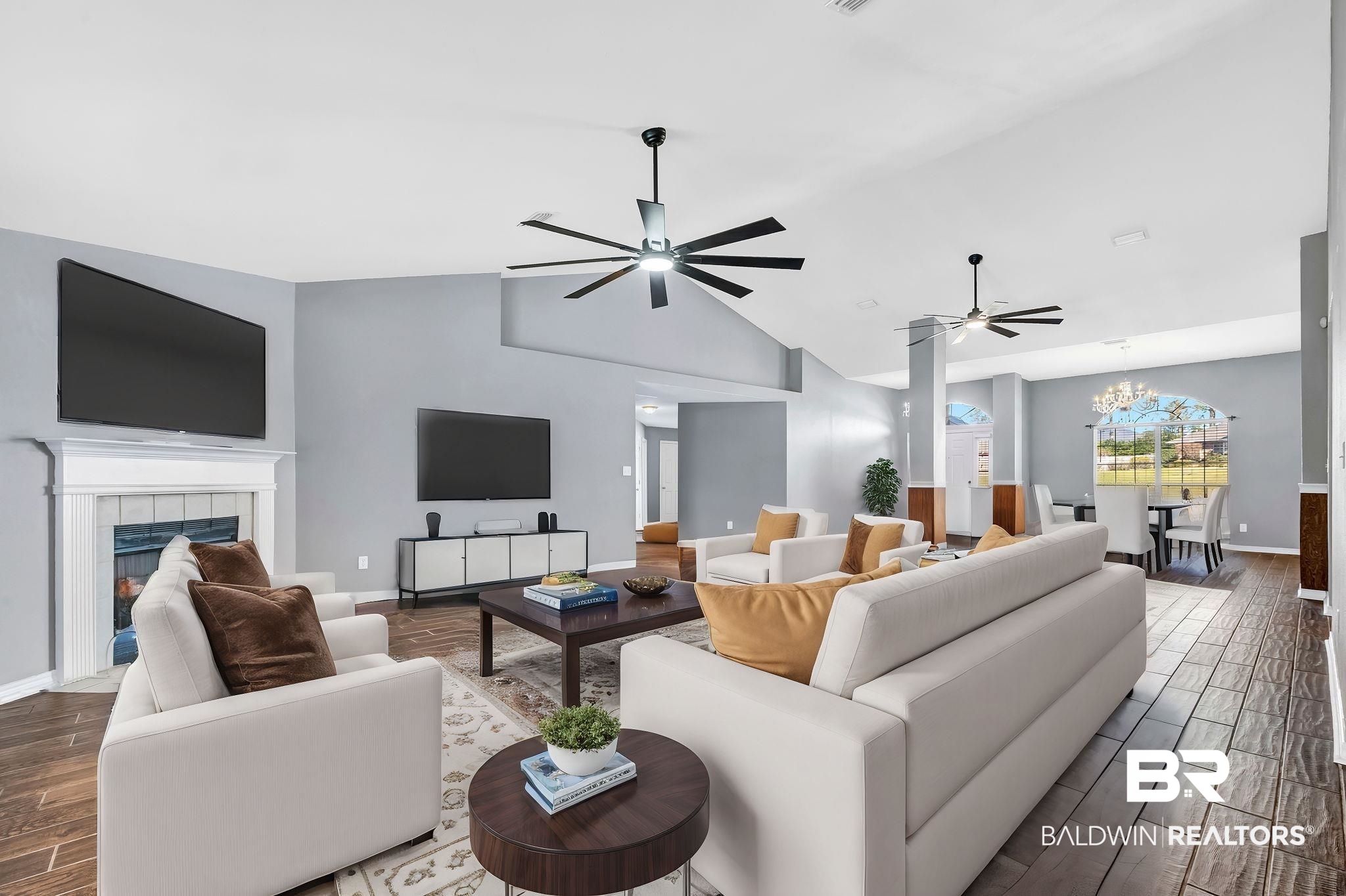 16444 Hamlet Lane Foley, AL 36535 - Photo 40 of 49 Living room featuring lofted ceiling, ceiling fan with notable chandelier, baseboards, a tiled fireplace, and wood tiled floor