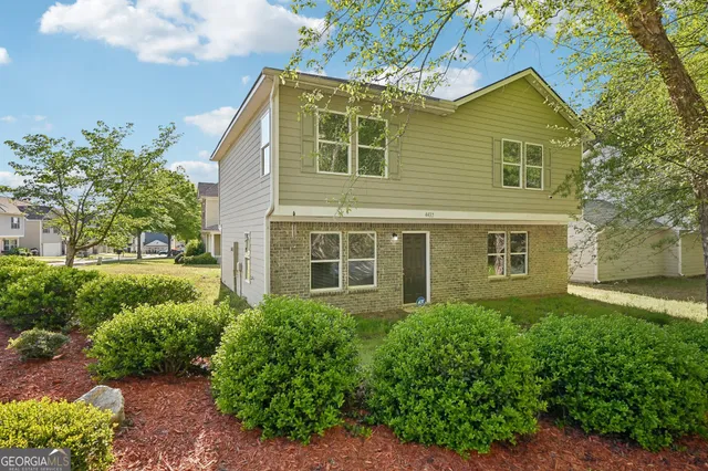 a front view of a house with a yard