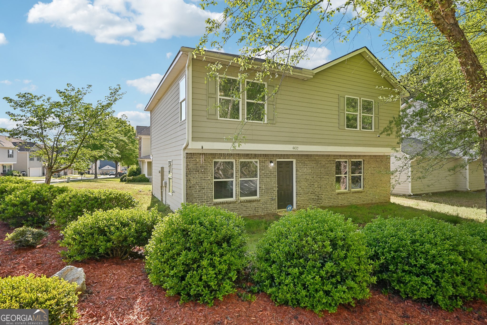 a front view of a house with a yard