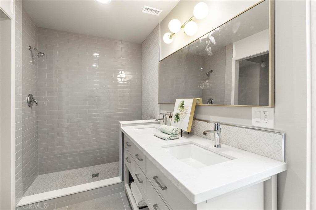 4084 Miramonte Place Riverside, CA 92501 - Photo 41 of 60 a bathroom with a sink double vanity and a mirror