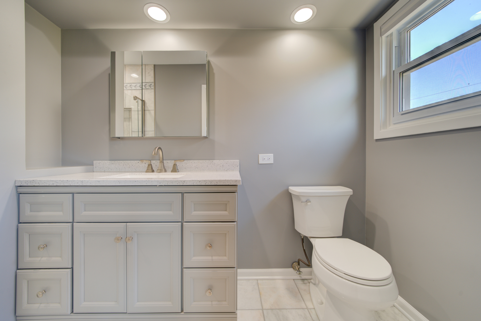 9211 Washington Road Morton Grove, IL 60053 - Photo 17 of 29 a bathroom with a toilet sink and mirror
