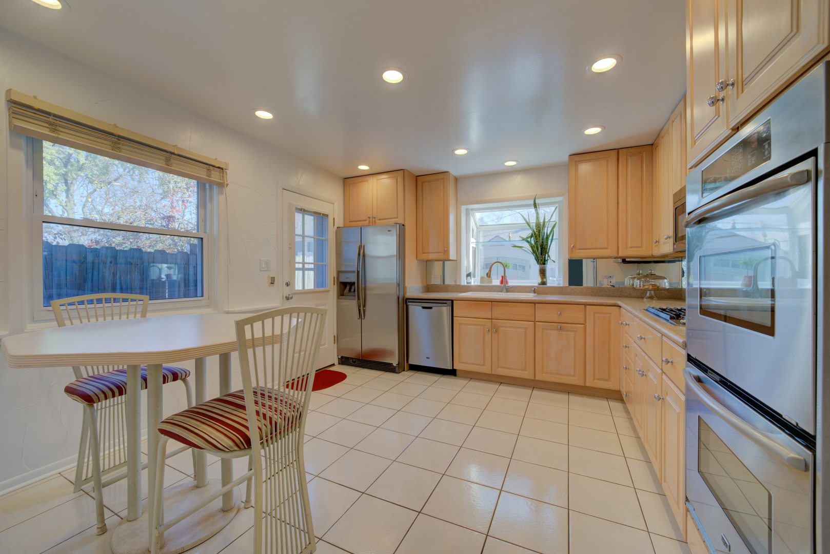 9211 Washington Road Morton Grove, IL 60053 - Photo 6 of 29 a kitchen with stainless steel appliances kitchen island granite countertop a sink and cabinets