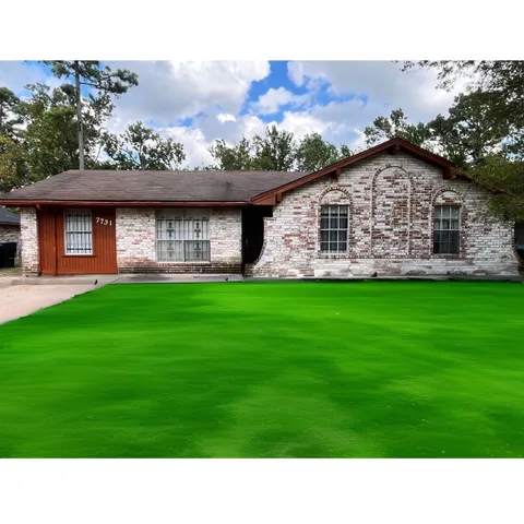 a black and white photo of a house with a yard