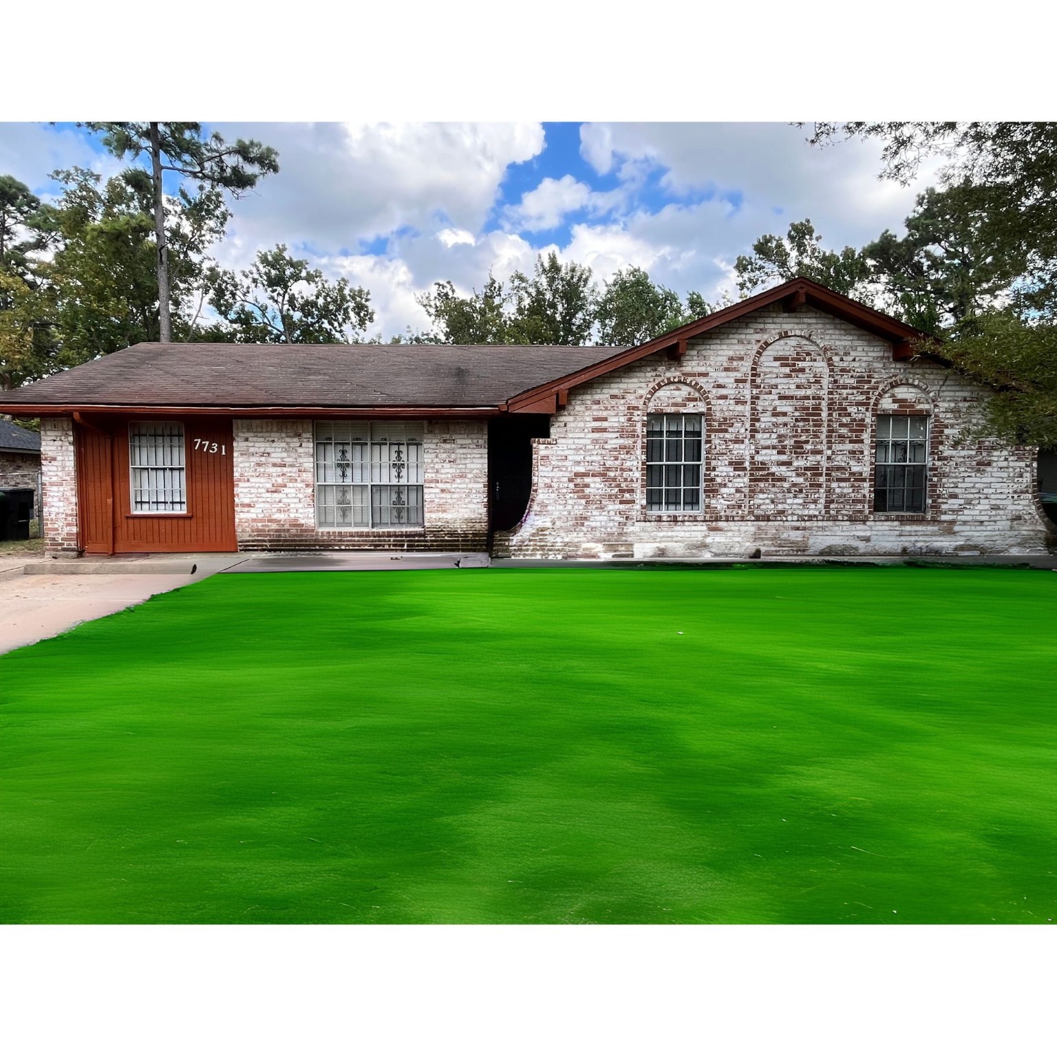 a black and white photo of a house with a yard