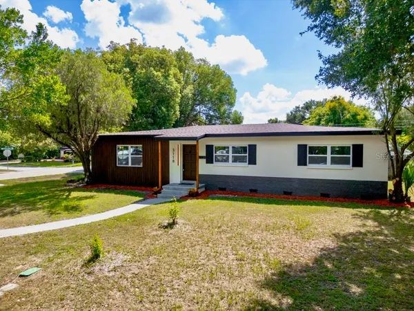 a view of a house with swimming pool and a yard