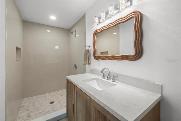 a bathroom with a sink vanity and a mirror