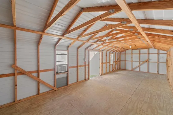 aerial view of a house with a yard and large trees