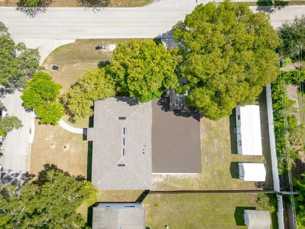 an aerial view of residential building with outdoor space and seating area