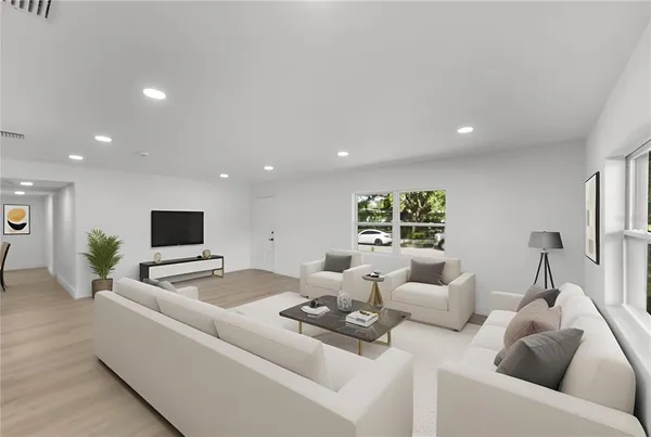 a living room with furniture and a flat screen tv