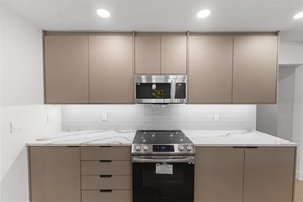 a kitchen with a sink stove and microwave