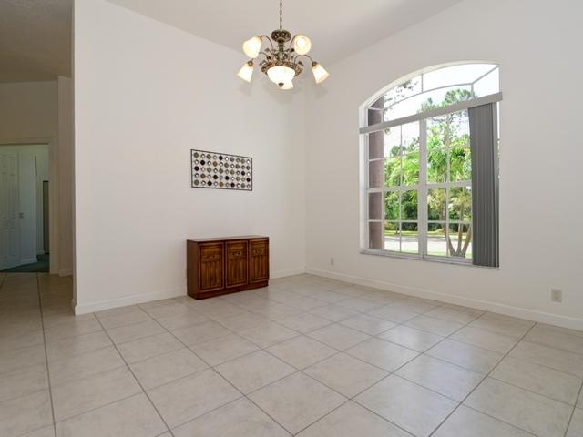 12557 154th Road North Jupiter, FL 33478 - Photo 7 of 38 a living room with a window and a chandelier