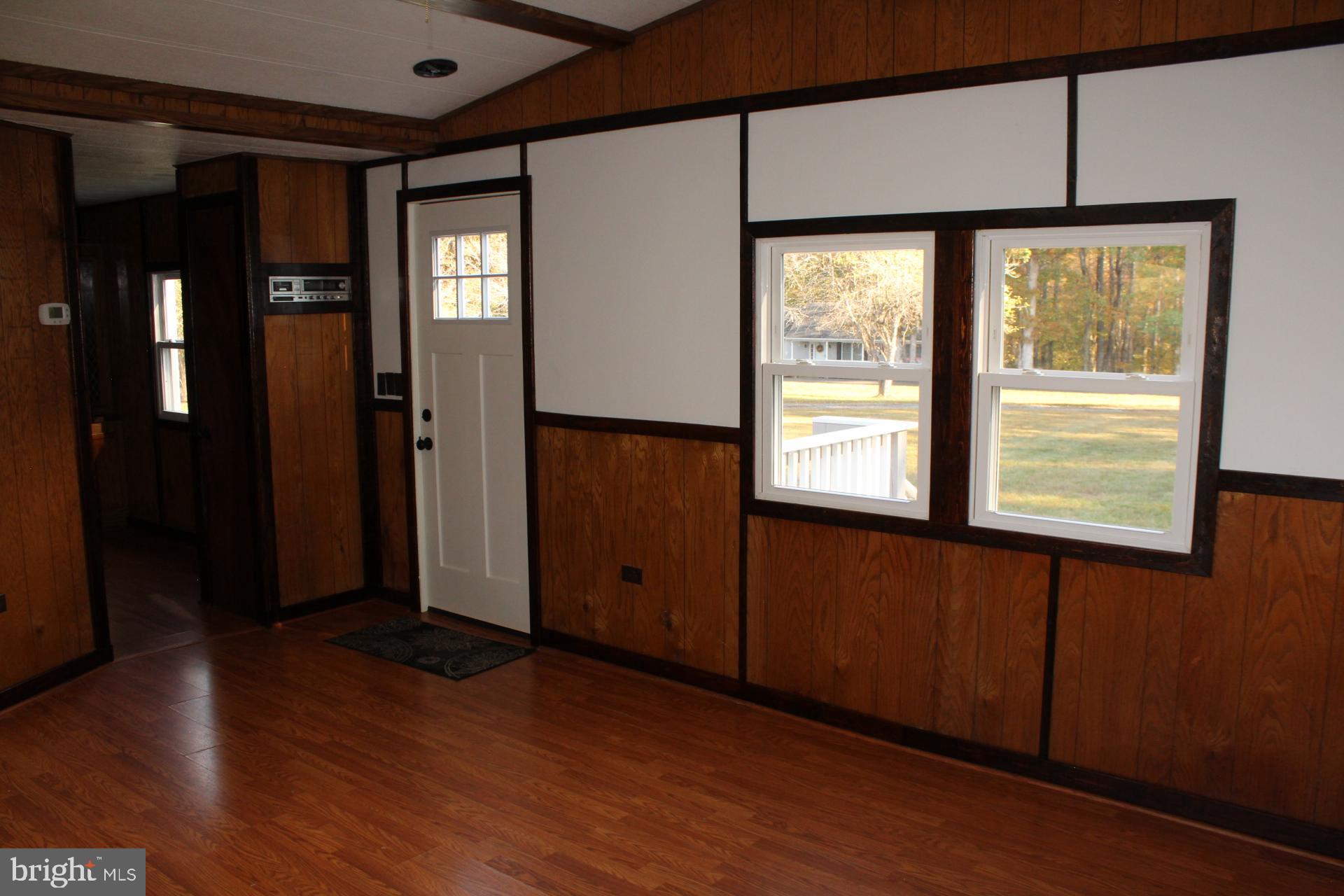 5274 Burr Hill Road Rhoadesville, VA 22542 - Photo 13 of 66 an empty room with wooden floor and windows