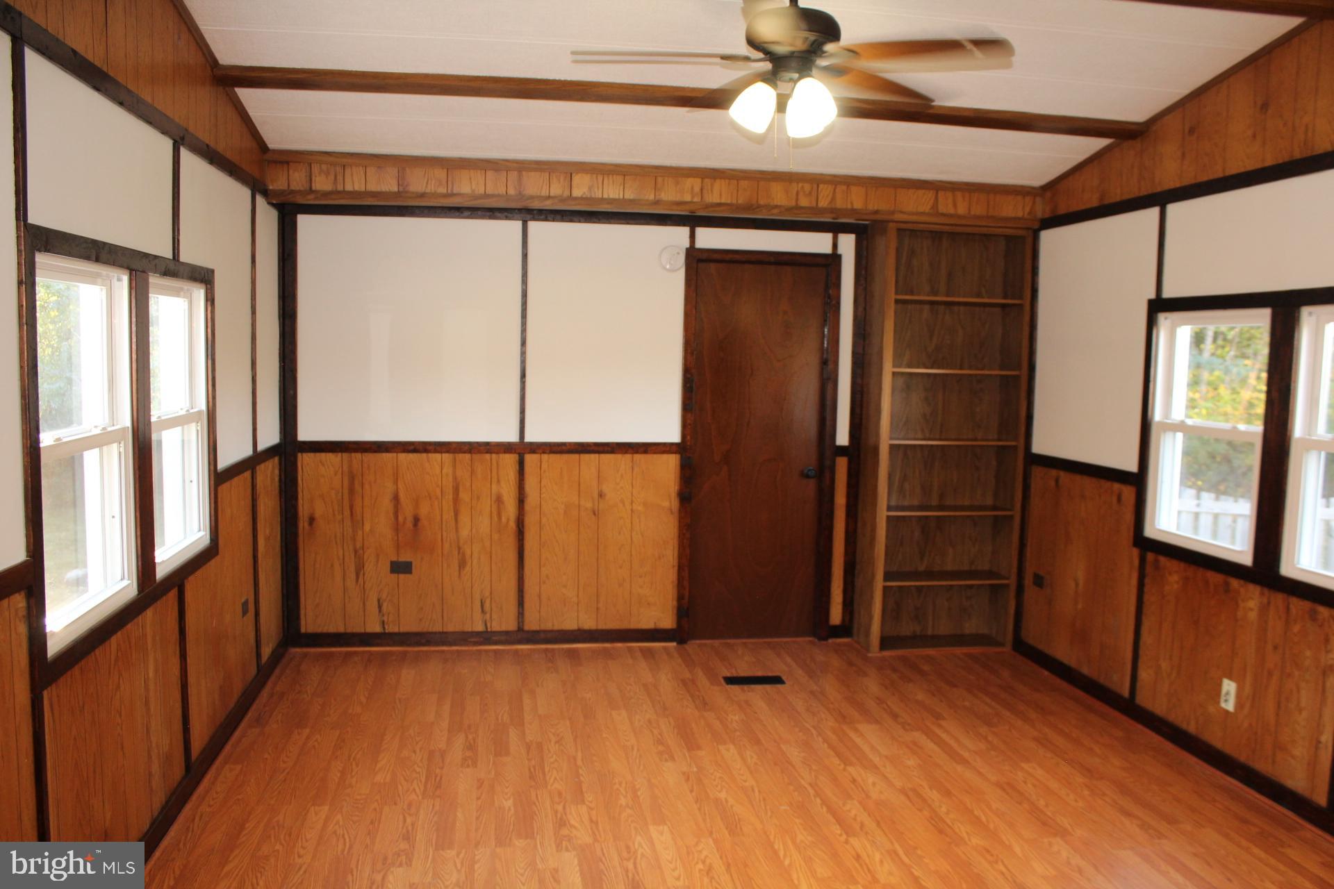 5274 Burr Hill Road Rhoadesville, VA 22542 - Photo 16 of 66 an empty room with wooden floor and windows