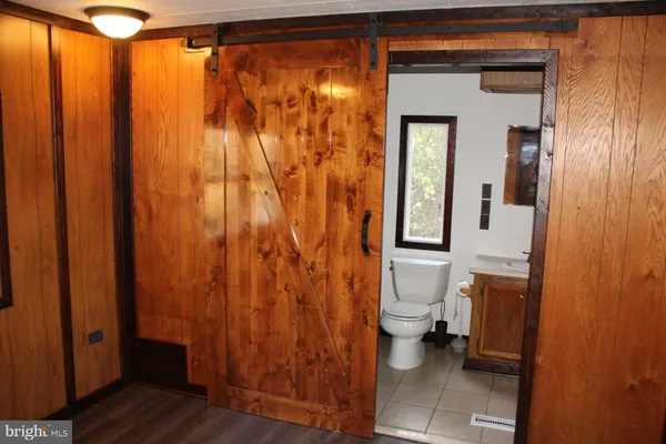 a view of a room with wooden floor and a window
