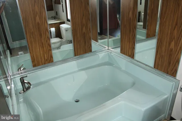 a kitchen with granite countertop a refrigerator and a sink