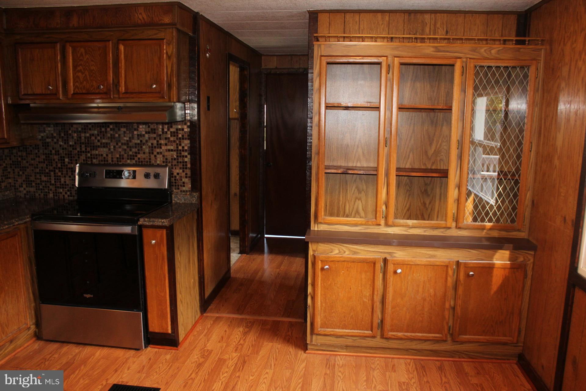 5274 Burr Hill Road Rhoadesville, VA 22542 - Photo 30 of 66 a kitchen with granite countertop stainless steel appliances and wooden cabinets