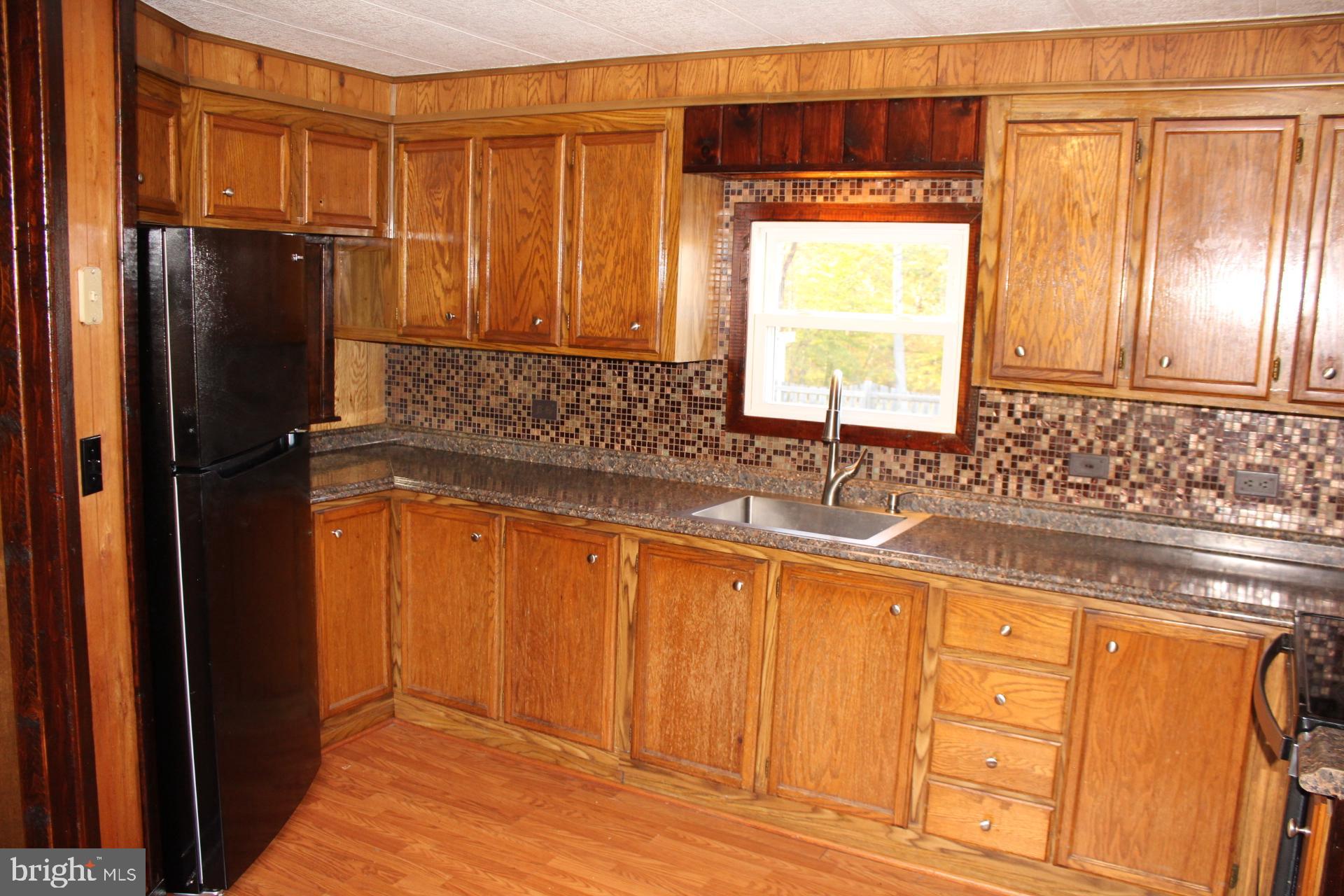 5274 Burr Hill Road Rhoadesville, VA 22542 - Photo 32 of 66 a bathroom with granite countertop a sink a window and stainless steel appliances