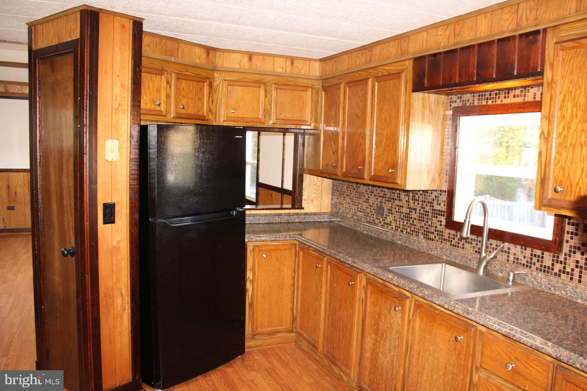 5274 Burr Hill Road Rhoadesville, VA 22542 - Photo 33 of 66 a kitchen with granite countertop a refrigerator and a sink