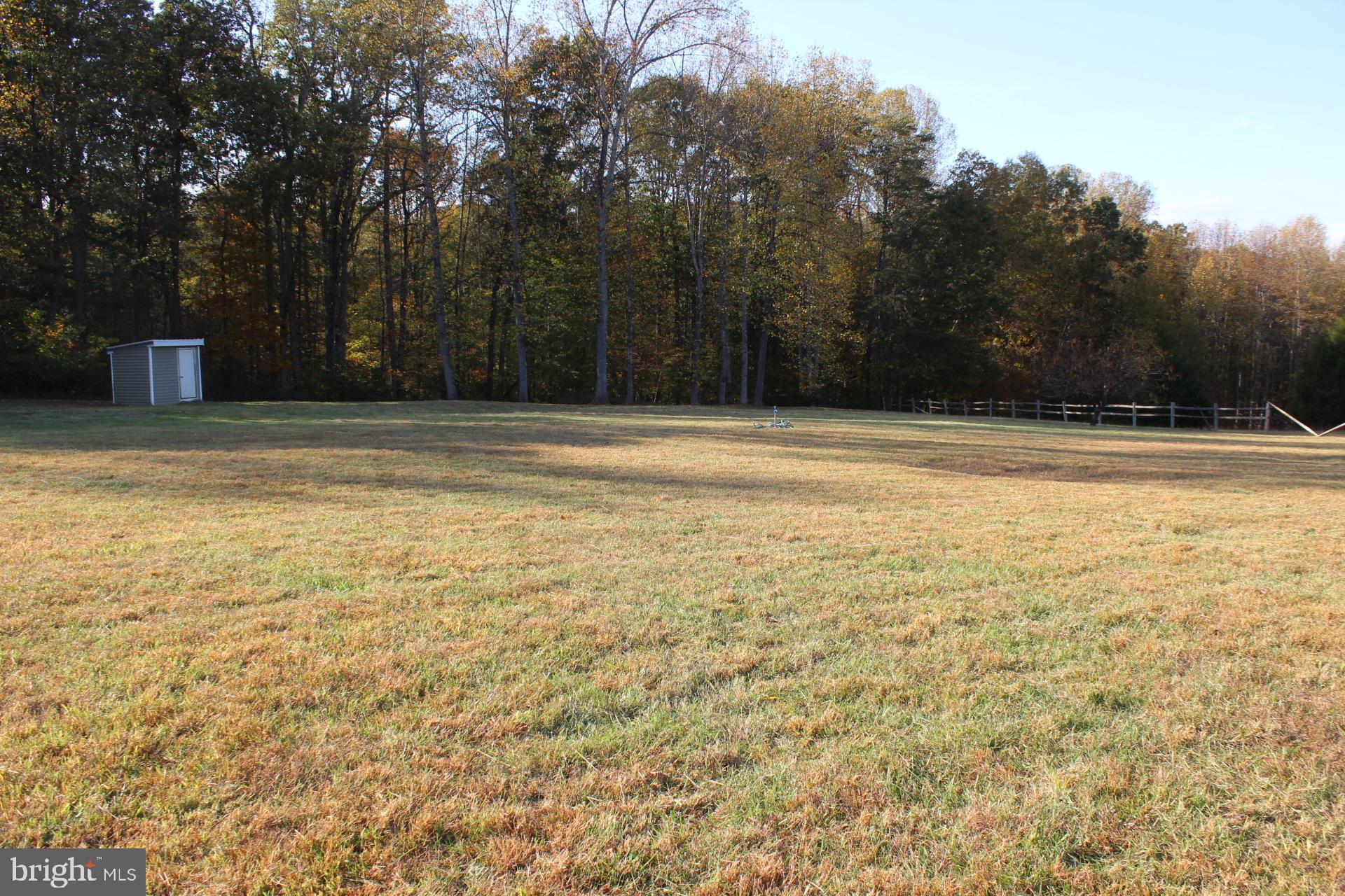 5274 Burr Hill Road Rhoadesville, VA 22542 - Photo 49 of 66 a view of a swimming pool and trees in the background