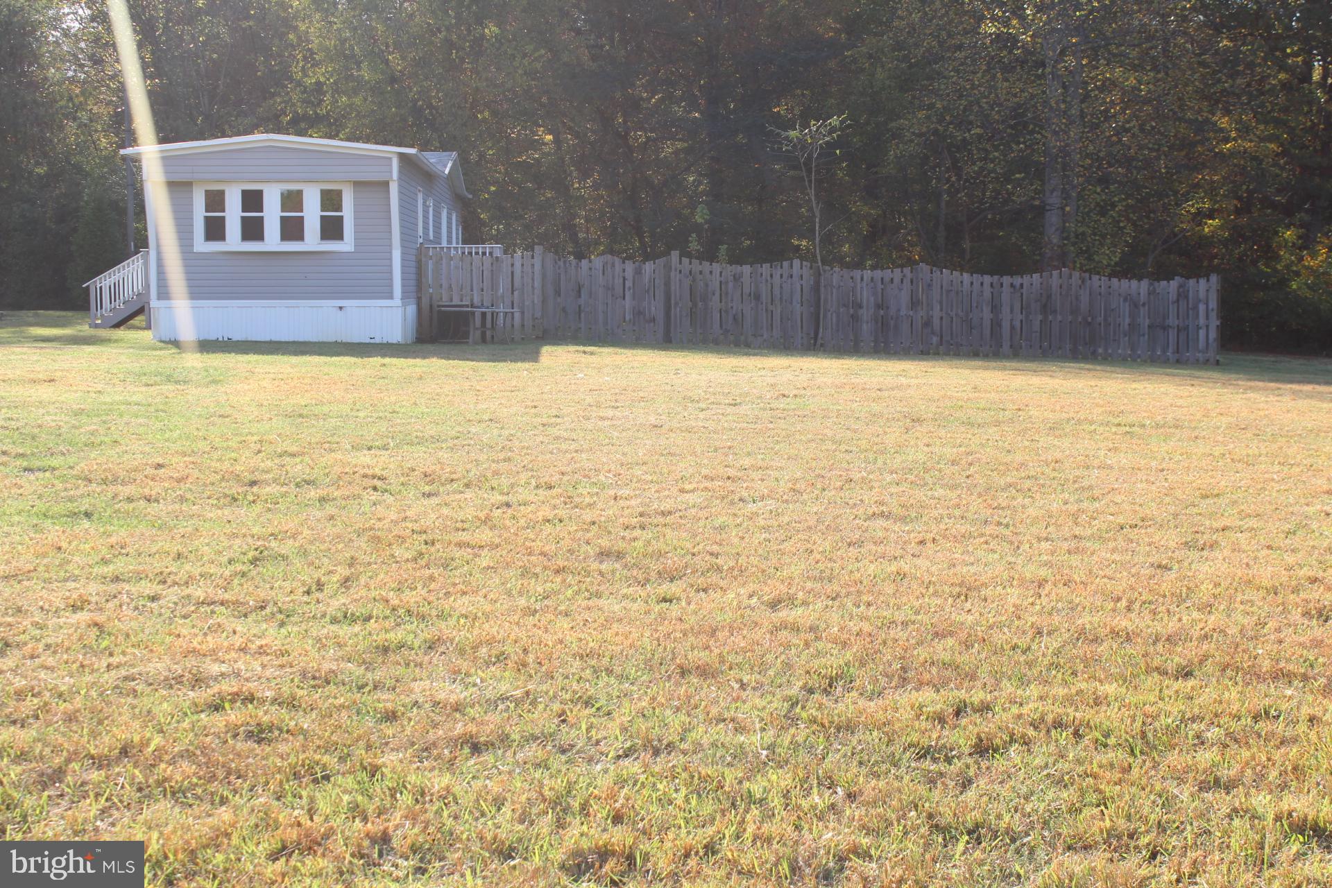5274 Burr Hill Road Rhoadesville, VA 22542 - Photo 50 of 66 a view of a swimming pool with an outdoor seating and yard