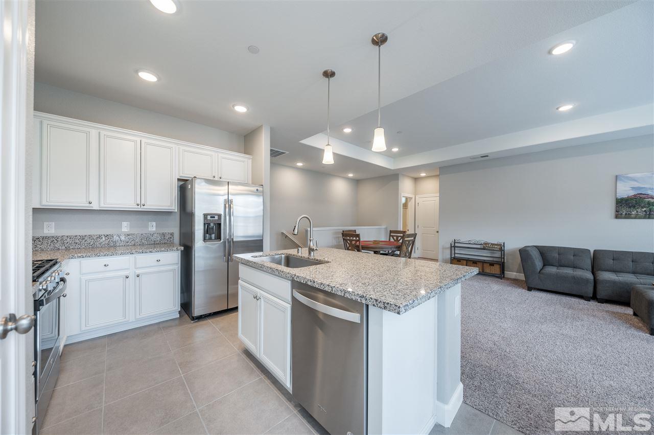 1852 Sea Horse Road, Unit A Reno, NV 89521 - Photo 9 of 21 a kitchen with stainless steel appliances granite countertop a sink a refrigerator and a stove
