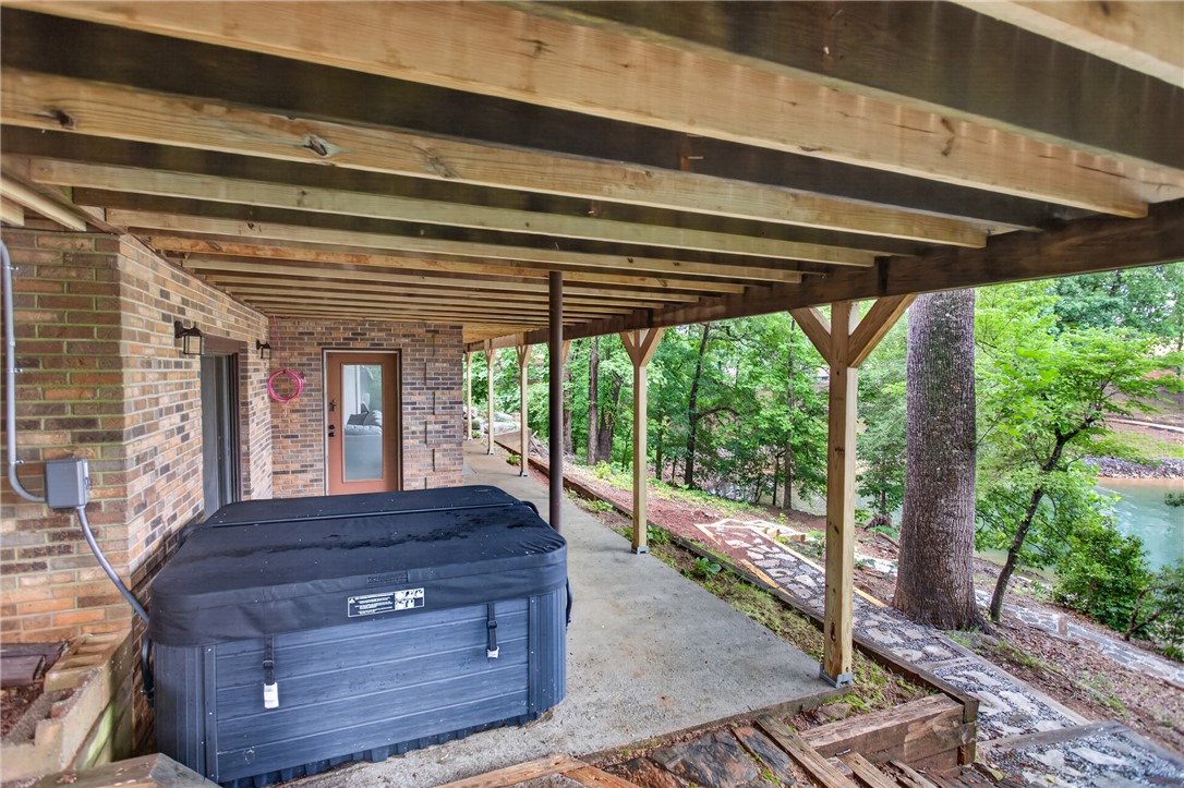 304 Lakeside Drive Seneca, SC 29672 - Photo 40 of 50 Unwind in the private hot tub nestled under the deck, with tranquil water views.