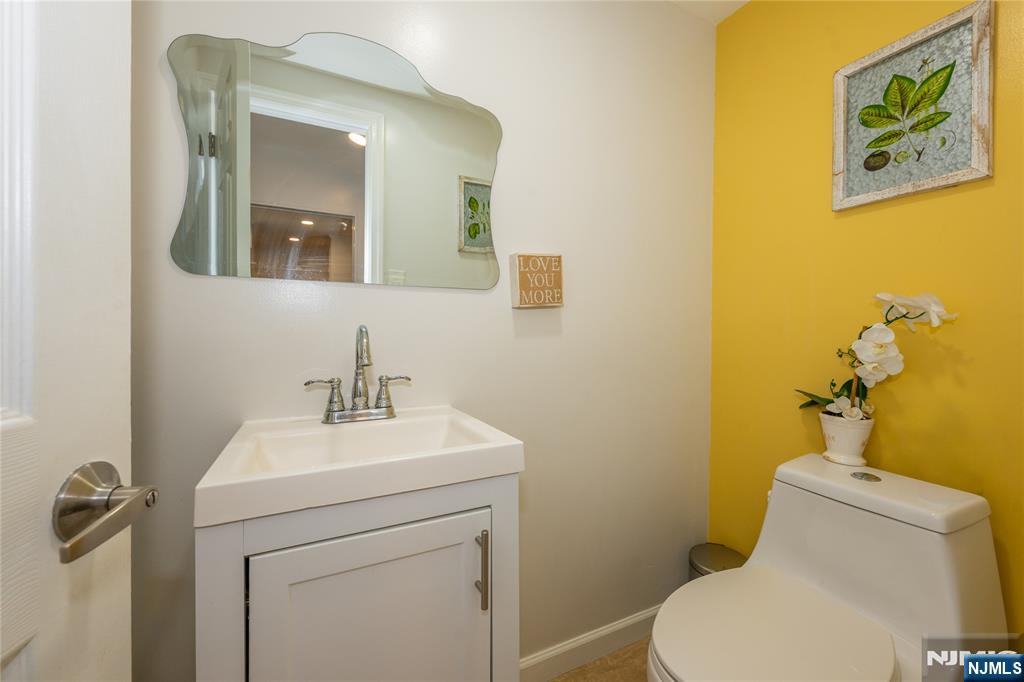 690 Garden Street Maywood, NJ 07607 - Photo 21 of 49 a bathroom with a toilet sink and mirror