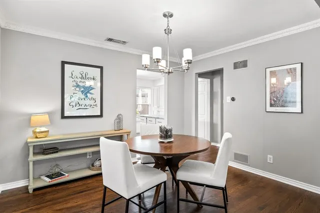 a view of a dining room with furniture wooden floor and chandelier