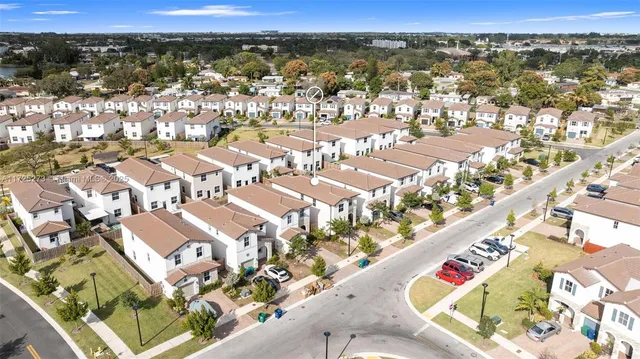 an aerial view of residential houses with outdoor space