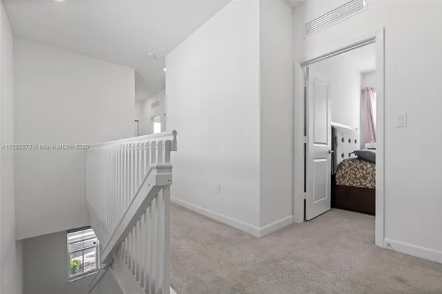 a view of a hallway with closet and stairs