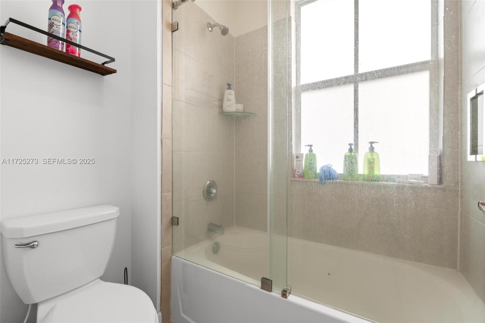 2357 Northwest 130th Street Miami, FL 33167 - Photo 39 of 48 a white toilet sitting next to a bath tub