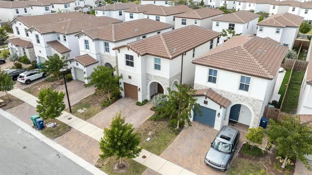 an aerial view of a house with a yard and potted plants