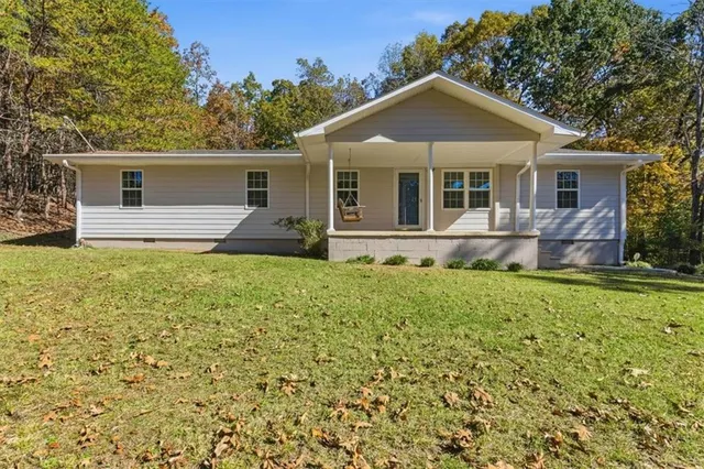 a front view of house with yard and green space