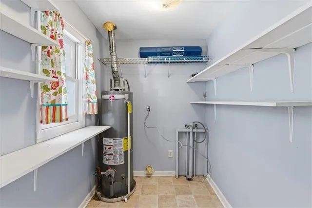 a view of storage and utility room with closet