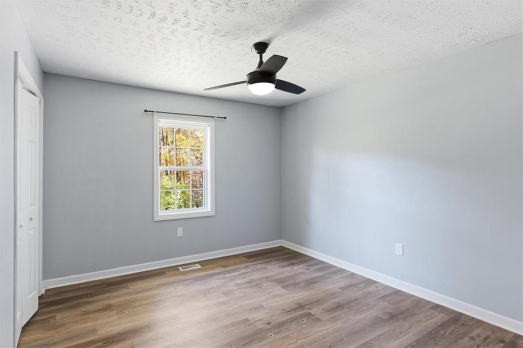 1500 Moores Ferry Road Southwest Plainville, GA 30733 - Photo 18 of 31 a view of empty room with wooden floor and fan