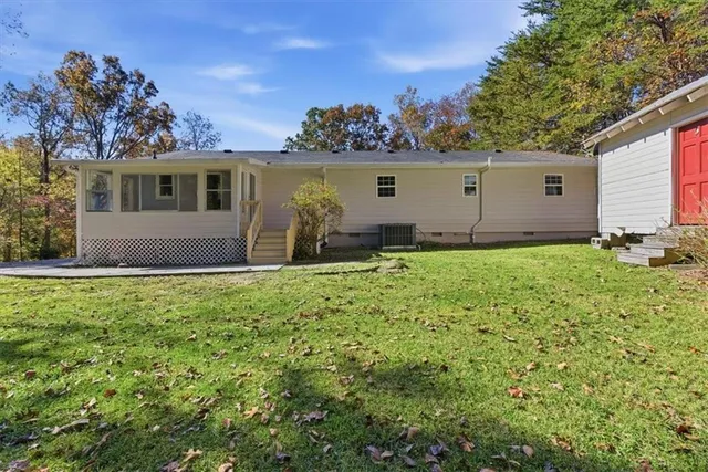a backyard of a house with table and chairs