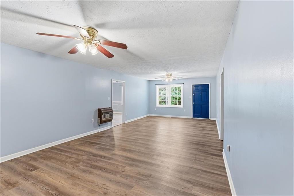 1500 Moores Ferry Road Southwest Plainville, GA 30733 - Photo 5 of 31 a view of an empty room with wooden floor and a window